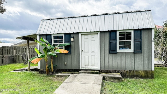 view of outbuilding featuring a lawn