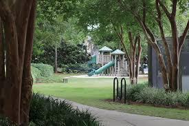 view of property's community featuring playground community and a lawn