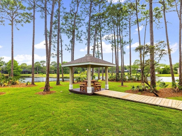 view of home's community with a water view, a yard, and a gazebo