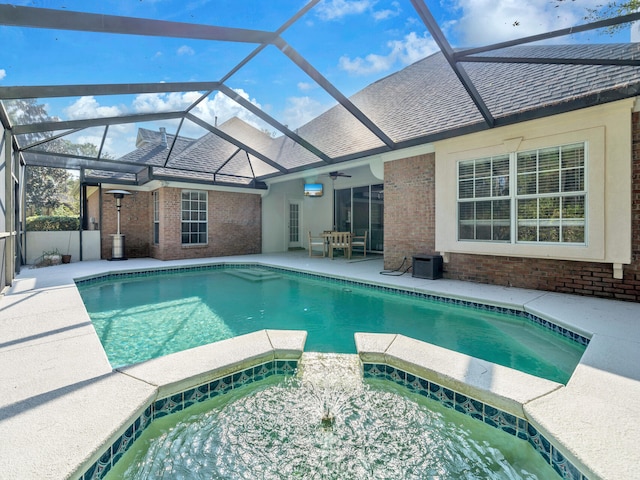 view of swimming pool with a ceiling fan, a pool with connected hot tub, and a patio area