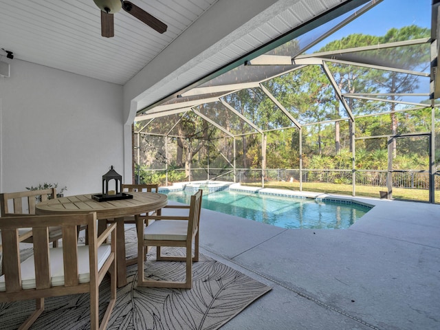 view of swimming pool featuring a lanai, a pool with connected hot tub, and a patio