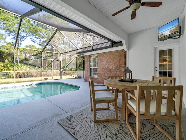 pool with outdoor dining space, a lanai, and a patio area