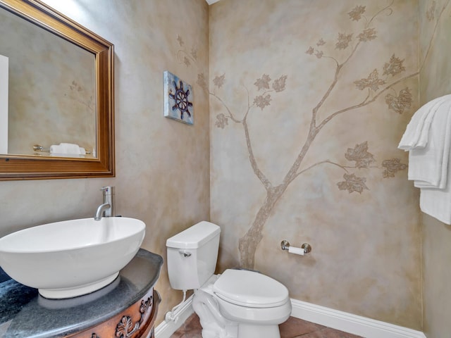 bathroom featuring toilet, tile patterned floors, baseboards, and vanity