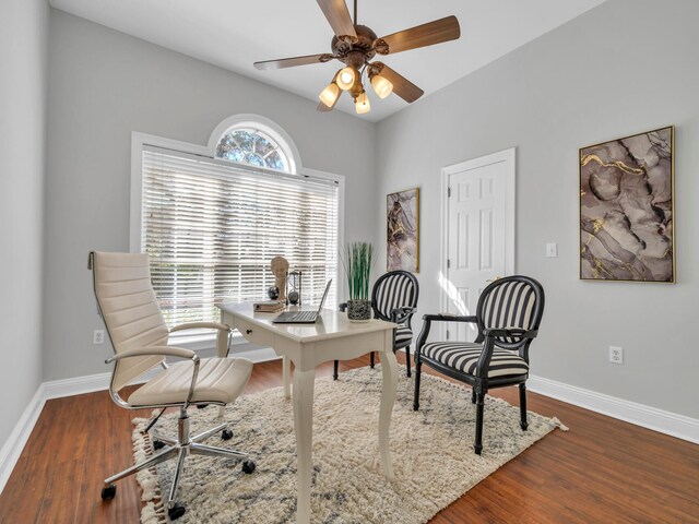 office space with wood finished floors, a ceiling fan, and baseboards