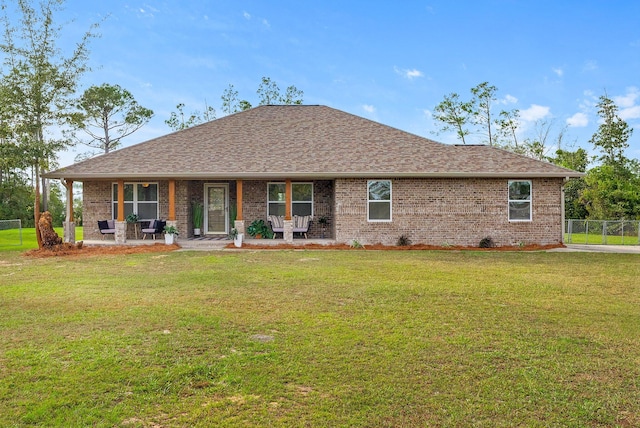 back of property featuring a yard