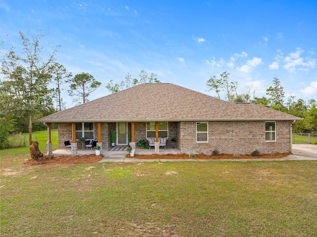 ranch-style home with a front yard and a patio area