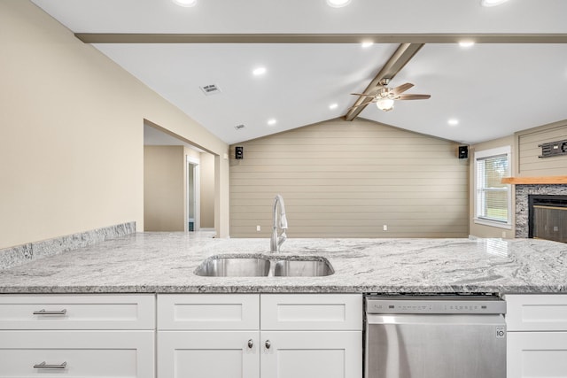 kitchen with dishwasher, vaulted ceiling with beams, sink, and wood walls