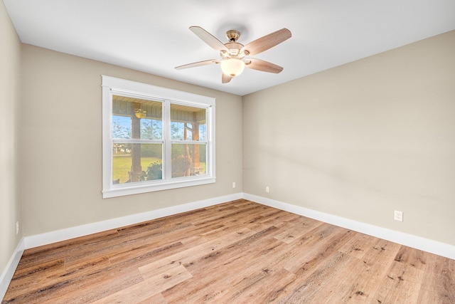 empty room with ceiling fan and light hardwood / wood-style flooring