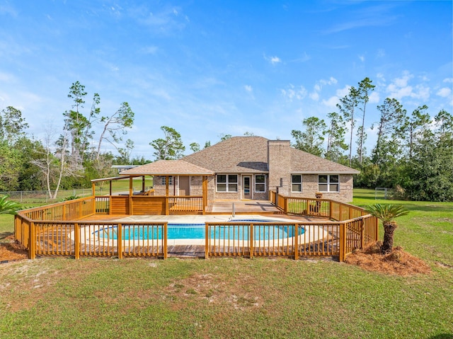 view of pool with a patio area and a lawn