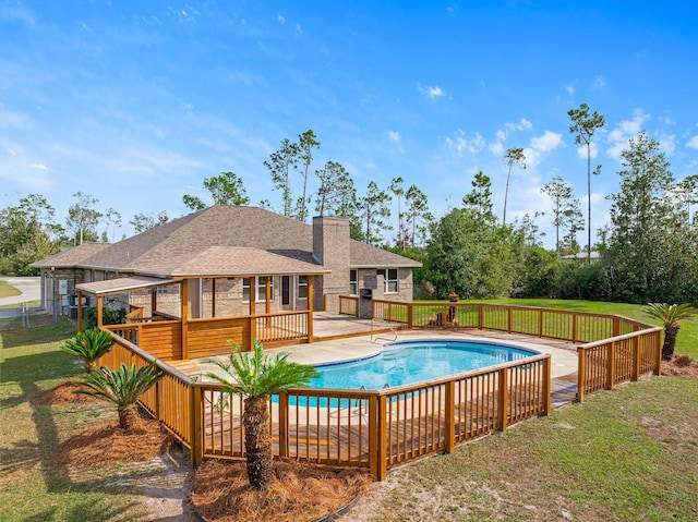 view of pool with a yard and a patio