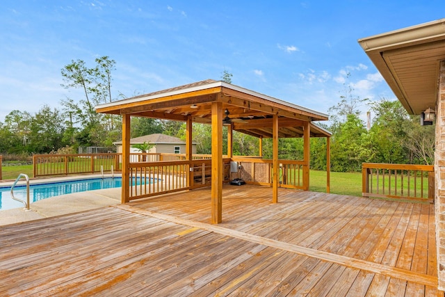 wooden deck with a fenced in pool