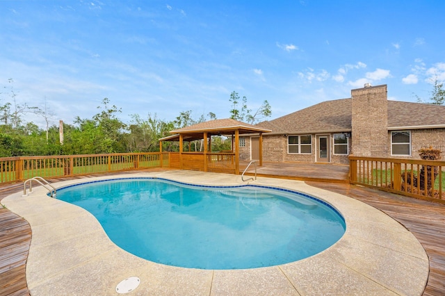 view of pool featuring a gazebo and a wooden deck