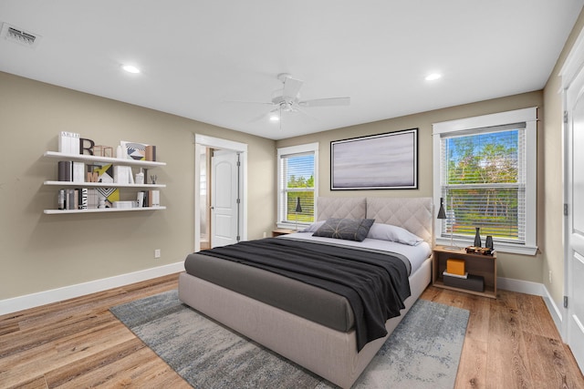 bedroom with hardwood / wood-style floors and ceiling fan