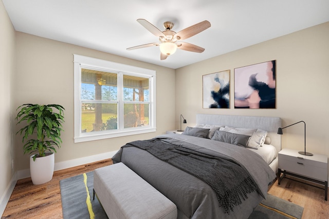 bedroom with ceiling fan and light hardwood / wood-style flooring