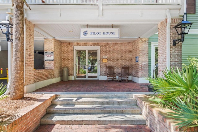 view of exterior entry with covered porch