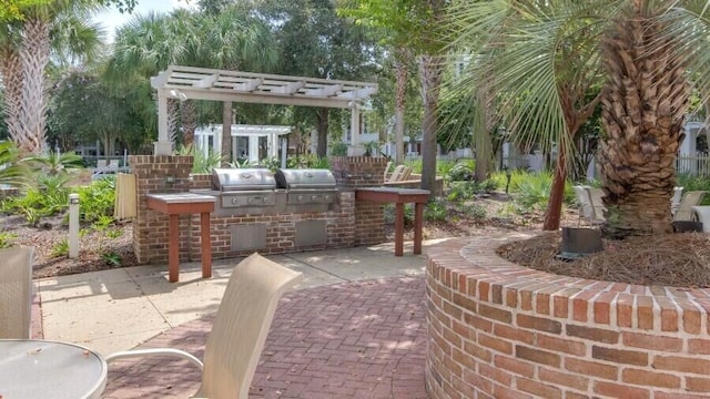 view of patio / terrace featuring an outdoor kitchen, area for grilling, a pergola, and exterior bar