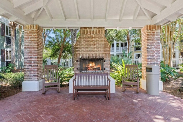 view of patio / terrace featuring an outdoor brick fireplace