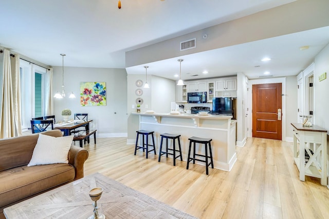 9300 Baytowne Wharf Blvd # 511, Miramar Beach, FL 32550 - living room with a chandelier and light hardwood / wood-style flooring