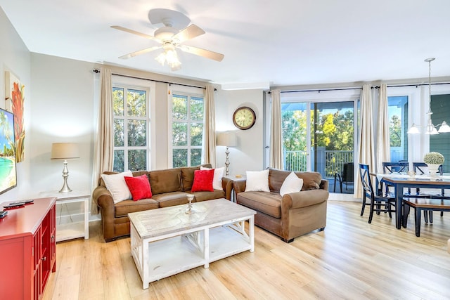 living room with ceiling fan and light hardwood / wood-style floors