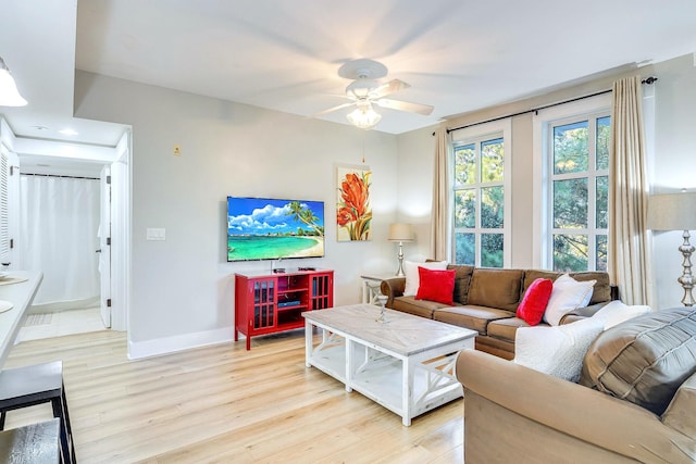 living room featuring ceiling fan and light hardwood / wood-style flooring