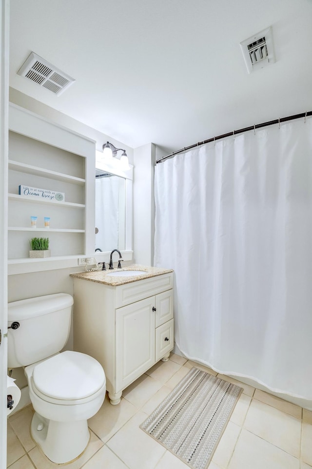 bathroom featuring tile patterned floors, vanity, and toilet