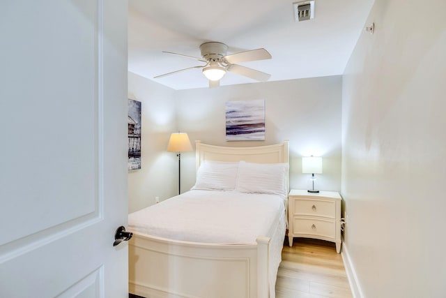 bedroom with ceiling fan and light hardwood / wood-style floors