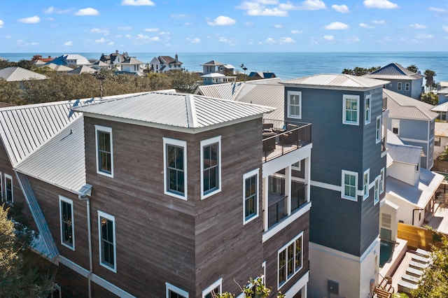 view of side of property with a balcony and a water view