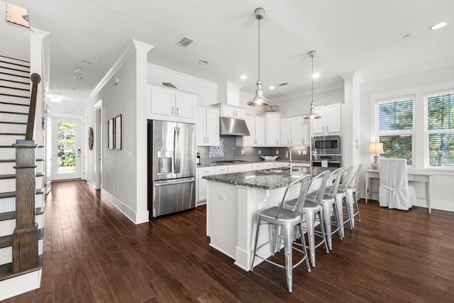 82 Gulfview Way, Santa Rosa Beach, FL 32459 - kitchen featuring stainless steel appliances, under cabinet range hood, ornamental molding, white cabinets, and tasteful backsplash
