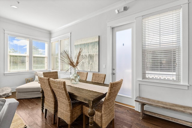 dining area featuring dark hardwood / wood-style flooring and crown molding