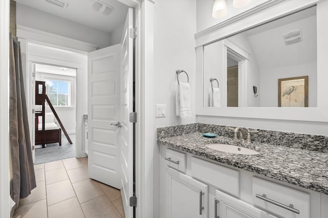 bathroom with vanity, tile patterned floors, and lofted ceiling