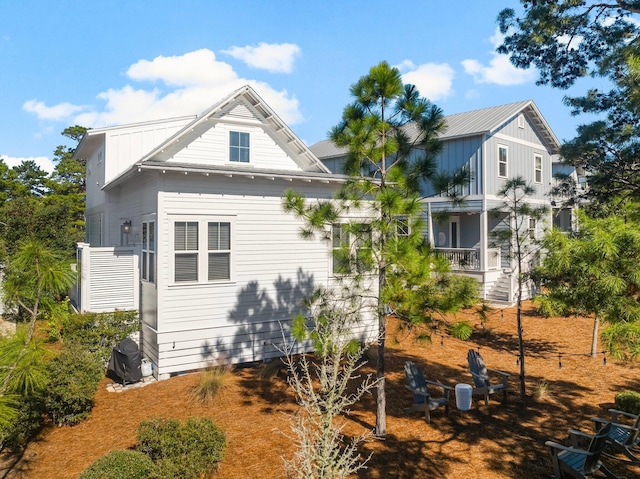 82 Gulfview Way, Santa Rosa Beach, FL 32459 - back of property with covered porch and board and batten siding