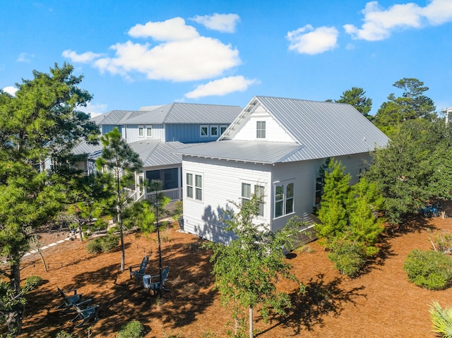 back of property with a sunroom