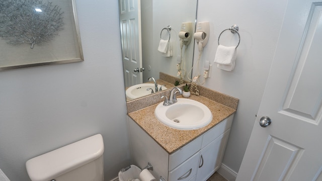 bathroom featuring vanity and toilet