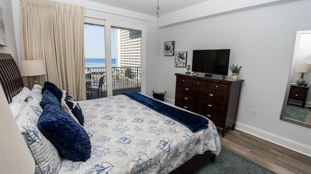 bedroom with hardwood / wood-style floors and access to outside