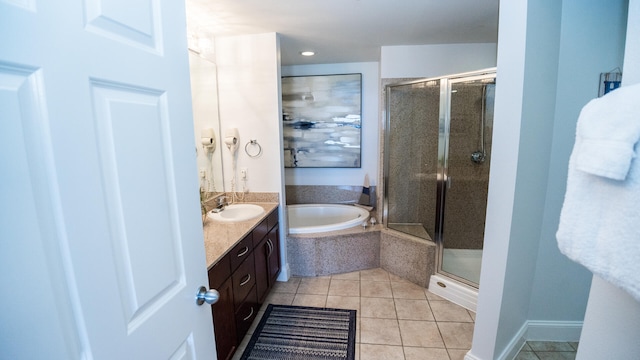 bathroom with tile patterned floors, vanity, and shower with separate bathtub