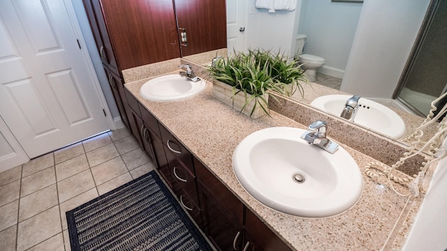 bathroom with tile patterned flooring, vanity, and toilet