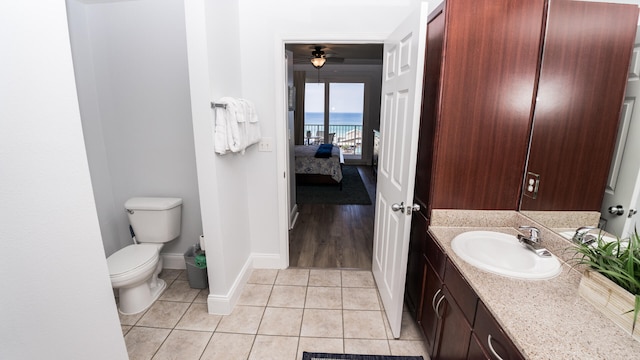 bathroom with vanity, ceiling fan, wood-type flooring, a water view, and toilet