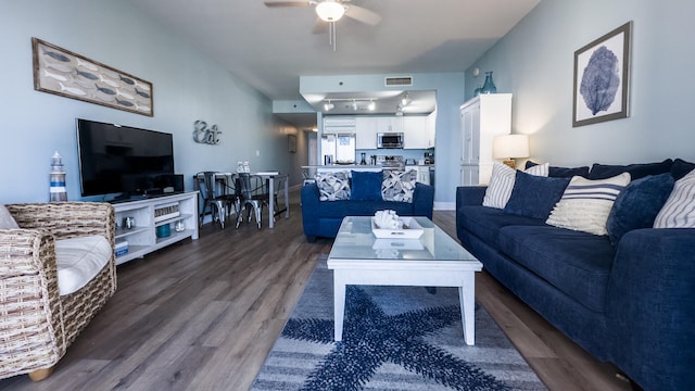 living room with dark hardwood / wood-style floors and ceiling fan