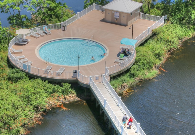 view of pool featuring a water view