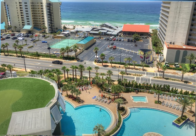 aerial view with a water view and a beach view