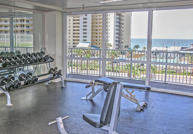 workout area featuring a water view