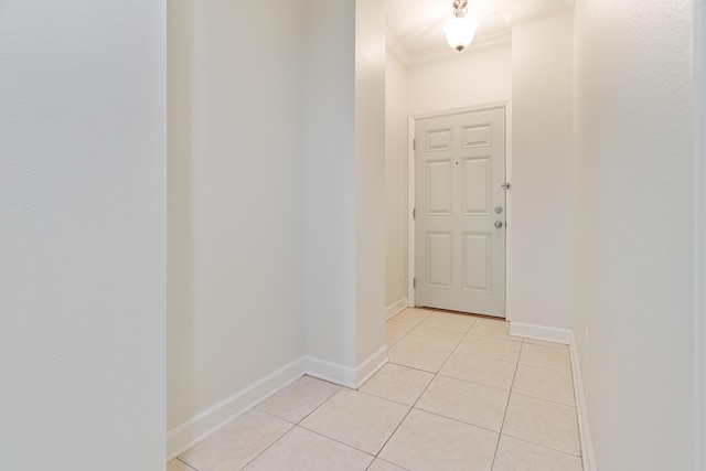 doorway featuring light tile patterned floors and crown molding