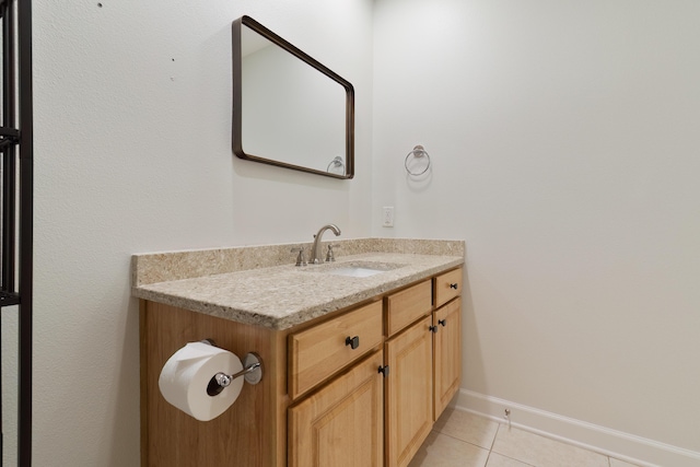 bathroom featuring tile patterned flooring, vanity, and baseboards