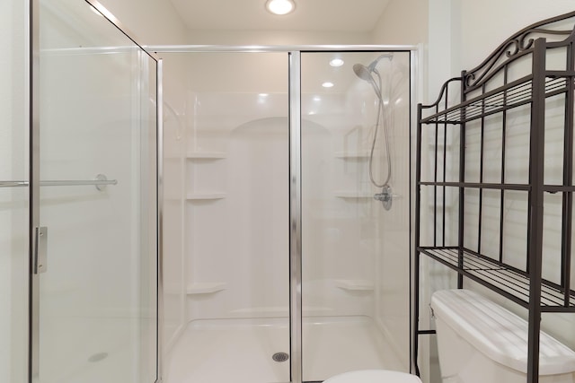 full bath featuring toilet, a stall shower, and recessed lighting