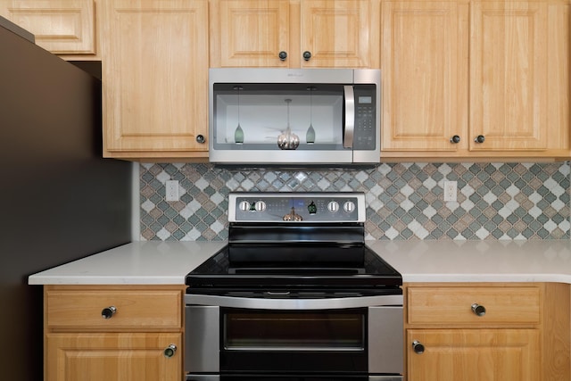 kitchen with decorative backsplash, light countertops, stainless steel appliances, and light brown cabinetry