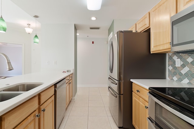 kitchen featuring light tile patterned floors, a sink, visible vents, light brown cabinets, and appliances with stainless steel finishes