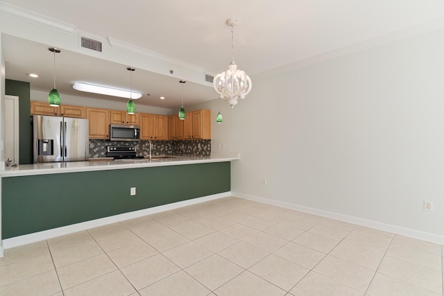 kitchen featuring a notable chandelier, a peninsula, stainless steel appliances, visible vents, and decorative backsplash