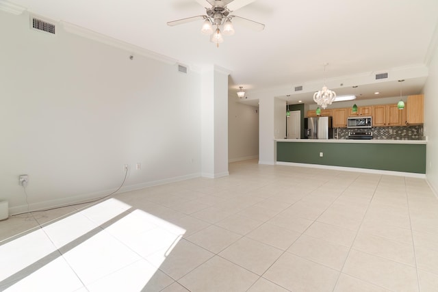 unfurnished living room featuring light tile patterned flooring, ceiling fan with notable chandelier, visible vents, and baseboards