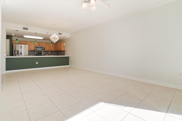 empty room featuring light tile patterned flooring, baseboards, visible vents, and ceiling fan with notable chandelier