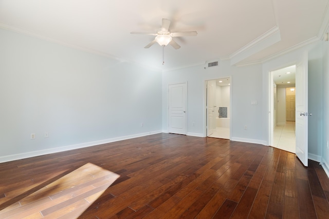spare room with crown molding, hardwood / wood-style flooring, baseboards, visible vents, and ceiling fan